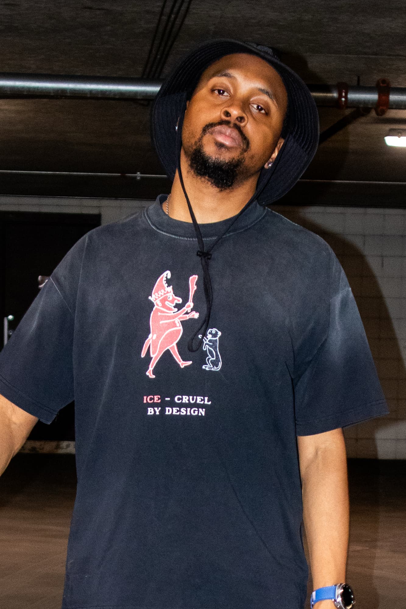 Model wearing the Cruel By Design tee, front print